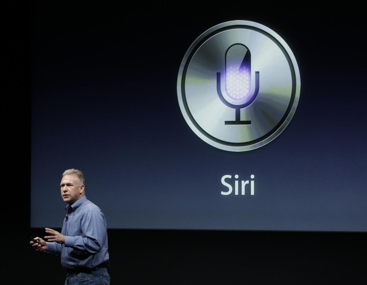 Apple executive Phil Schiller introduces Siri during an announcement at Apple headquarters in 2011.