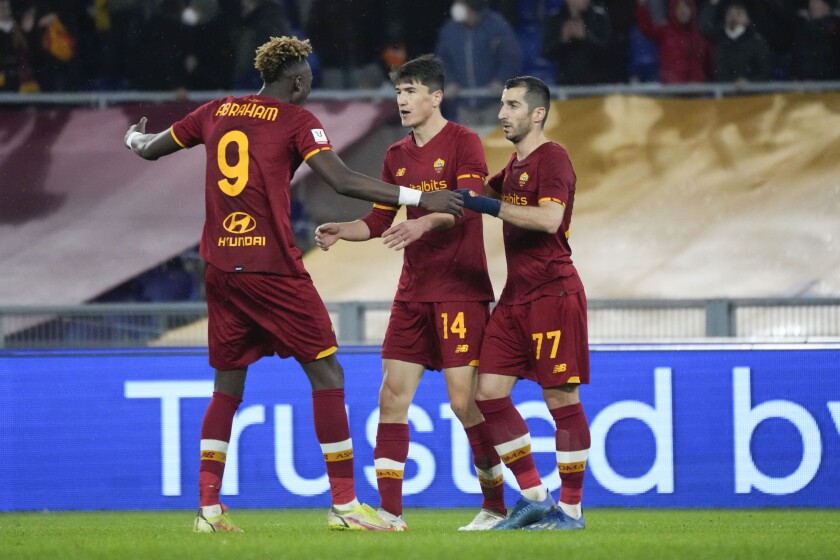 Roma's Eldor Shomurodov, center, is cheered by teammates Roma's Tammy Abraham, left, and Roma's Henrikh Mkhitaryan after scoring during the Italian Cup soccer match between Roma and Lecce at Rome's Olympic stadium, Thursday, Jan. 20, 2022. (AP Photo/Alessandra Tarantino)