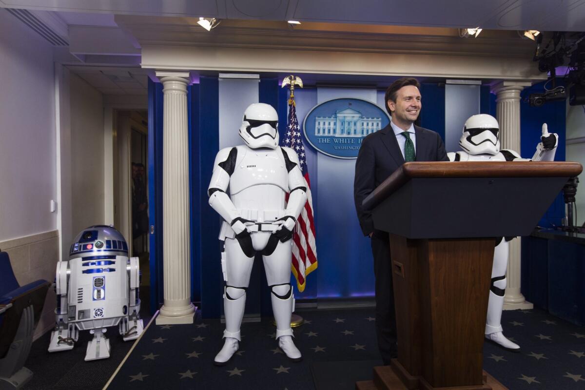 White House Press Secretary Josh Earnest with Stormtroopers and R2-D2 at a Friday morning press briefing.