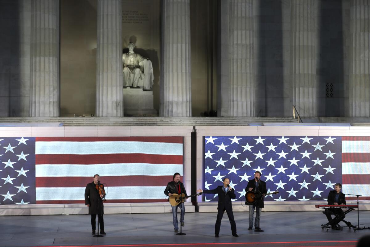 Lee Greenwood, third from left, sings with the backing of the Frontmen of Country at a pre-inaugural "Make America Great Again! Welcome Celebration" at the Lincoln Memorial in Washington on Jan. 19.