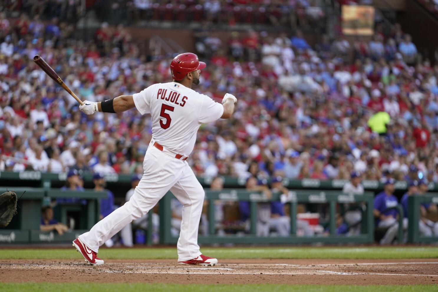 Nolan Gorman of the St. Louis Cardinals raises his bat as he runs