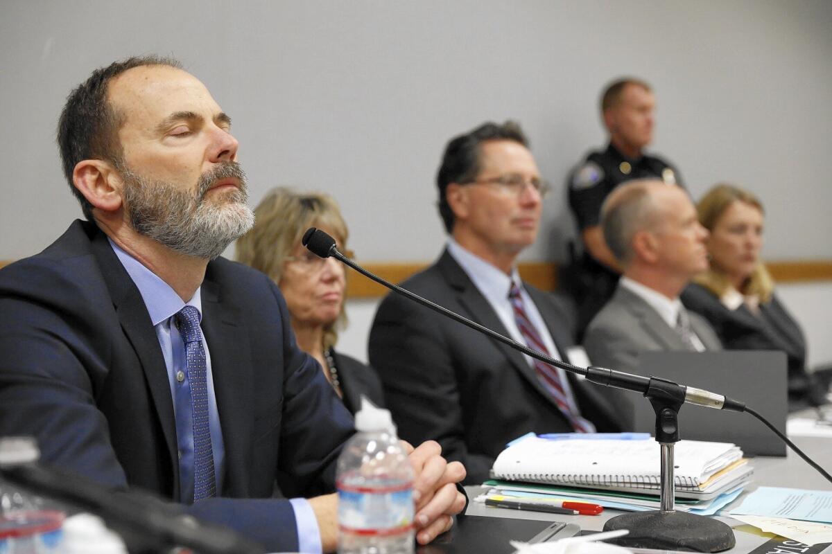 Charles Lester, left, reacts as he hears the vote to fire him as executive director of the California Coastal Commission.