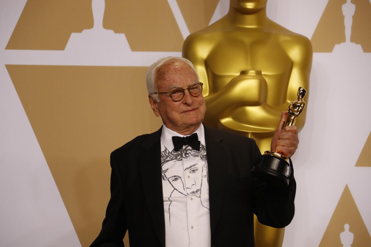 James Ivory, winner of the Oscar for adapted screenplay, for "Call Me by Your Name" poses backstage at the Oscars.
