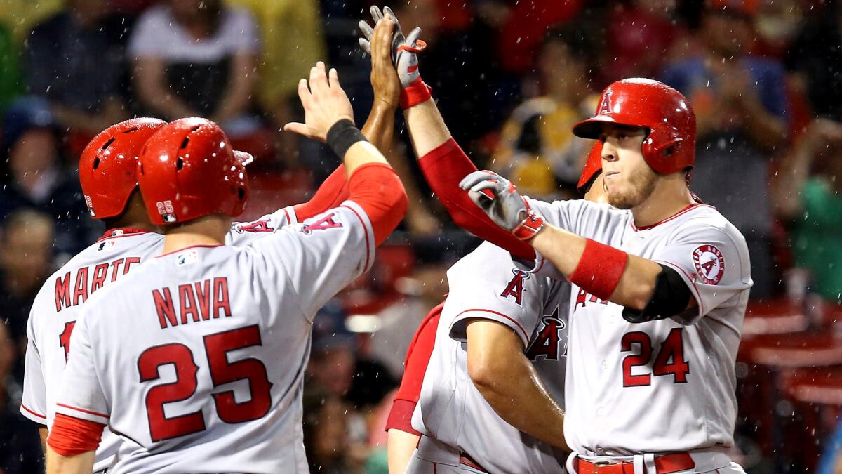 Angels first baseman C.J. Cron is congratulated by teammates after hitting a grand slam against the Red Sox in the sixth inning Friday night in Boston.