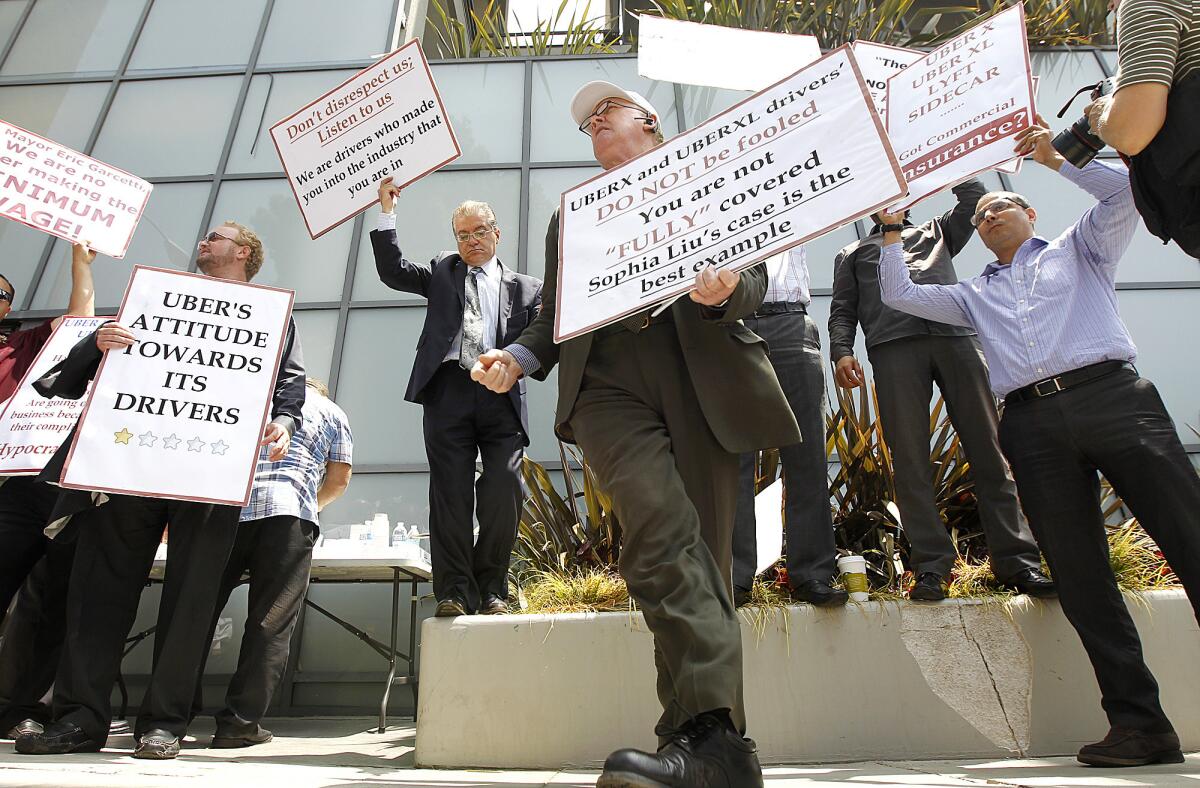 On Tuesday, Uber drivers, including Donal O'Sullivan, center, gather in Santa Monica to protest the company's alleged arbitrary treatment and unsafe practices.