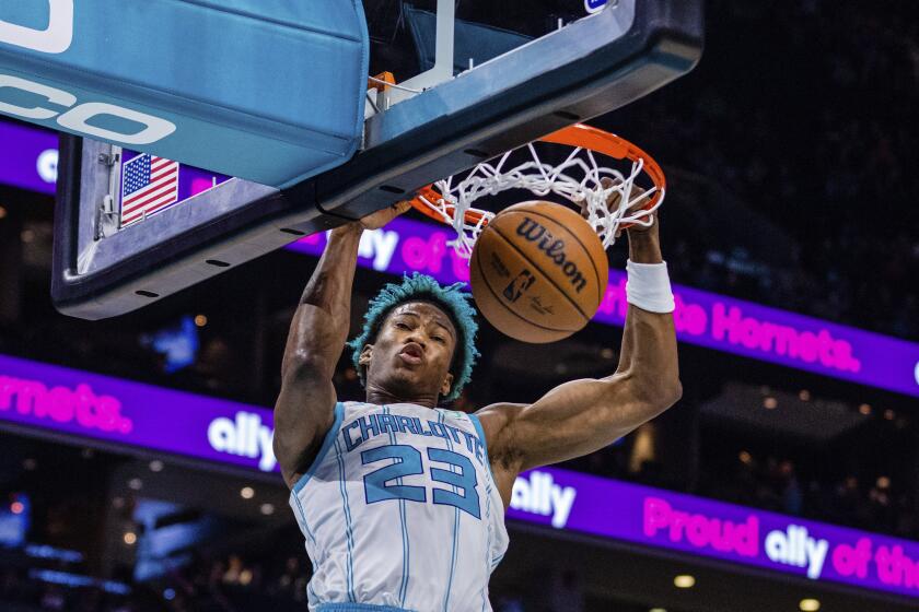 FILE - Charlotte Hornets forward Kai Jones dunks during the first half of an NBA basketball game against the Orlando Magic, March 3, 2023, in Charlotte, N.C. The Hornets announced Saturday, Sept. 30, 2023, that 2021 first-round draft pick Jones will not participate in training camp due to personal reasons. (AP Photo/Scott Kinser, File)