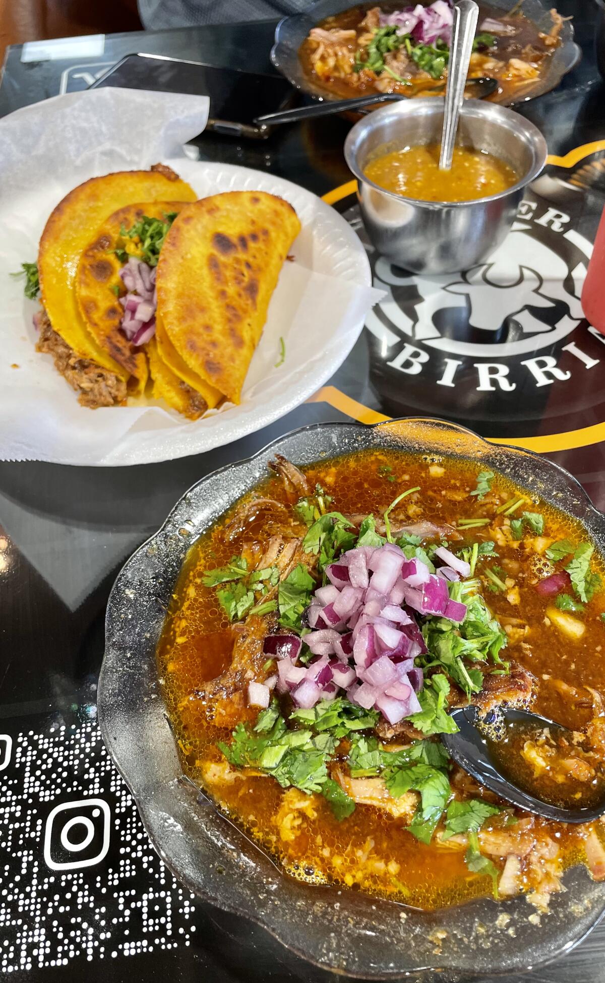 A bowl of birria and dorado taco at La Super Birria, located on First Street in Santa Ana.