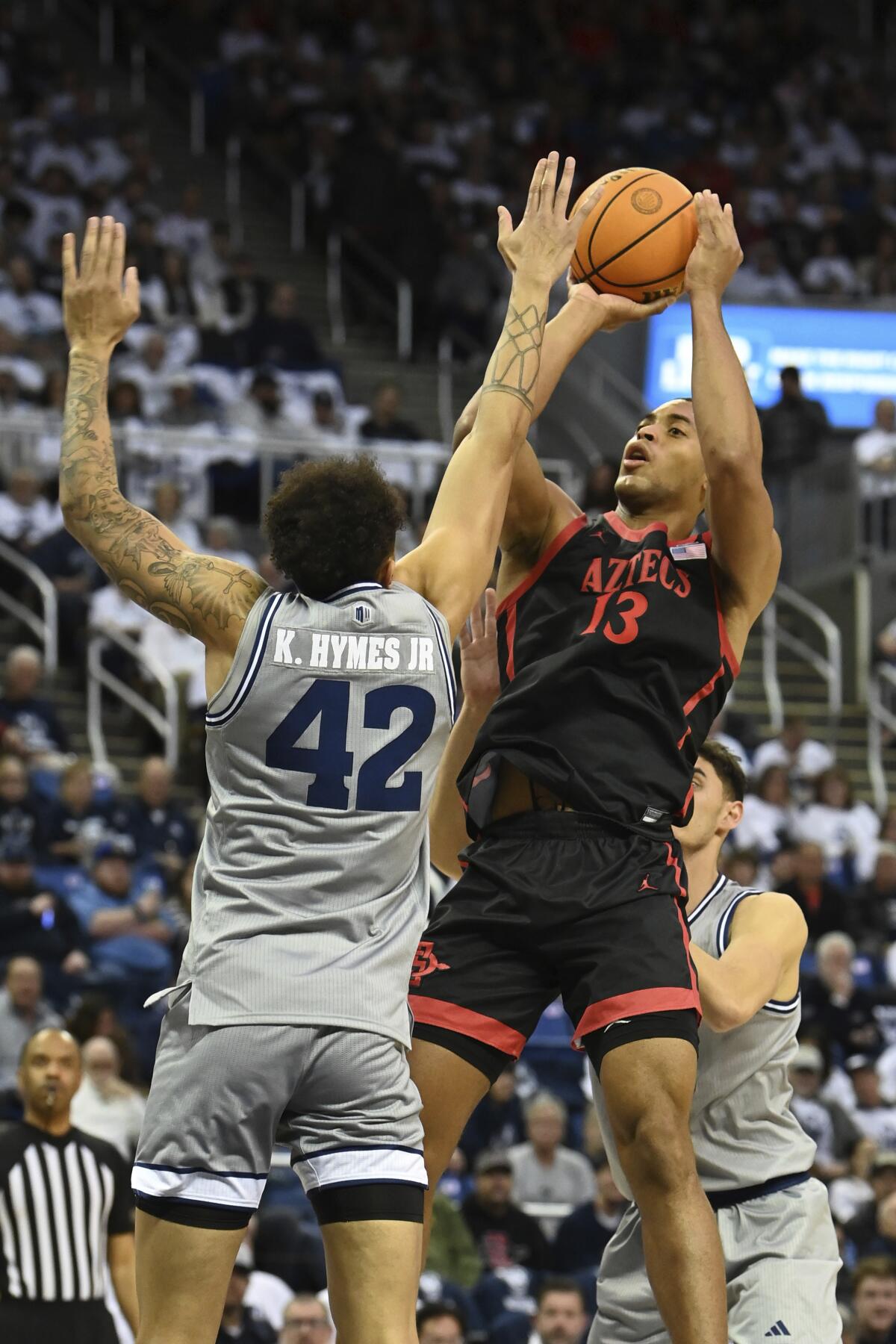 San Diego State's Jaedon LeDee shoots against Nevada's K.J. Hymes during the first half.