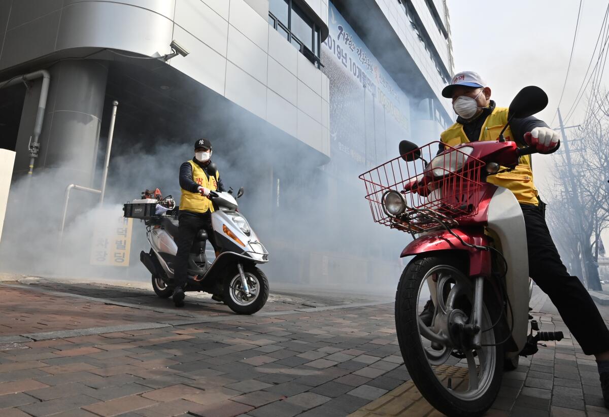 Workers spray disinfectant in front of the Daegu branch of the Shincheonji Church of Jesus in the southeastern city of Daegu on February 21.
