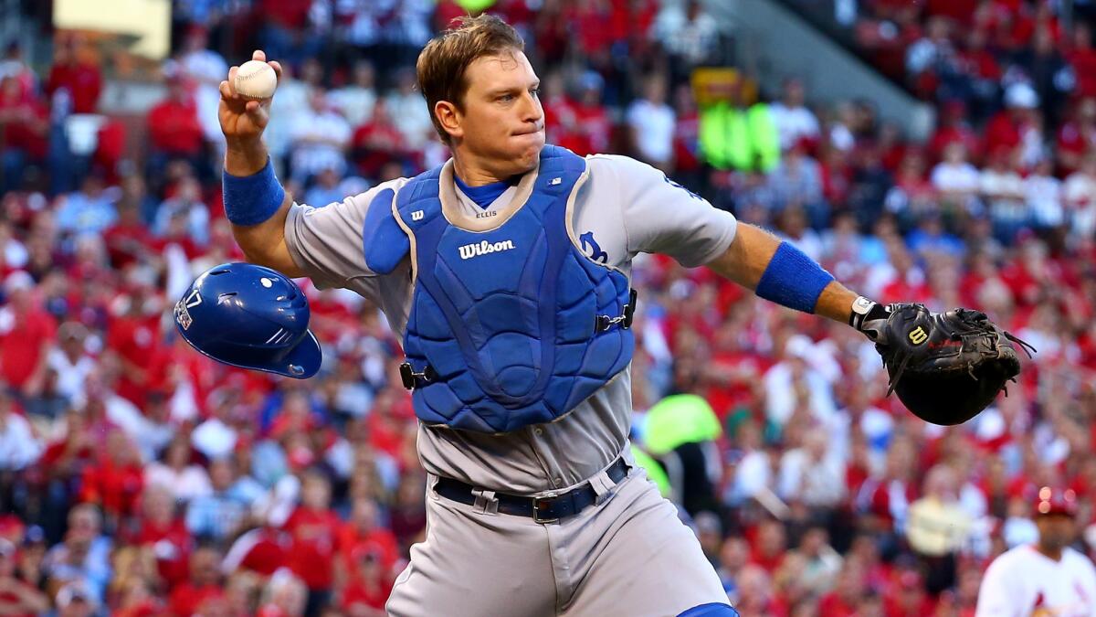 Dodgers catcher A.J. Ellis throws to first base during Game 4 of the National League division series against the St. Louis Cardinals on Oct. 7.