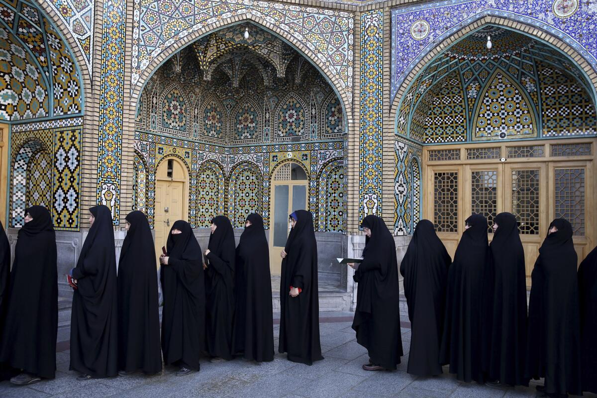 Women stand in line at a polling station during the parliamentary and Experts Assembly elections in Qom, Iran, on Feb. 26, 2016.