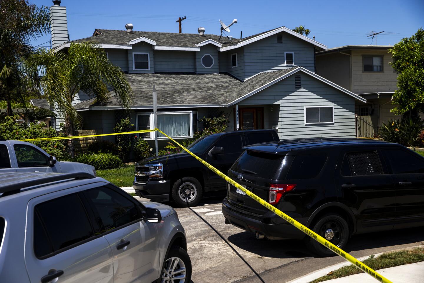 Law enforcement officials search a Long Beach property in connection with the Aliso Viejo explosion.
