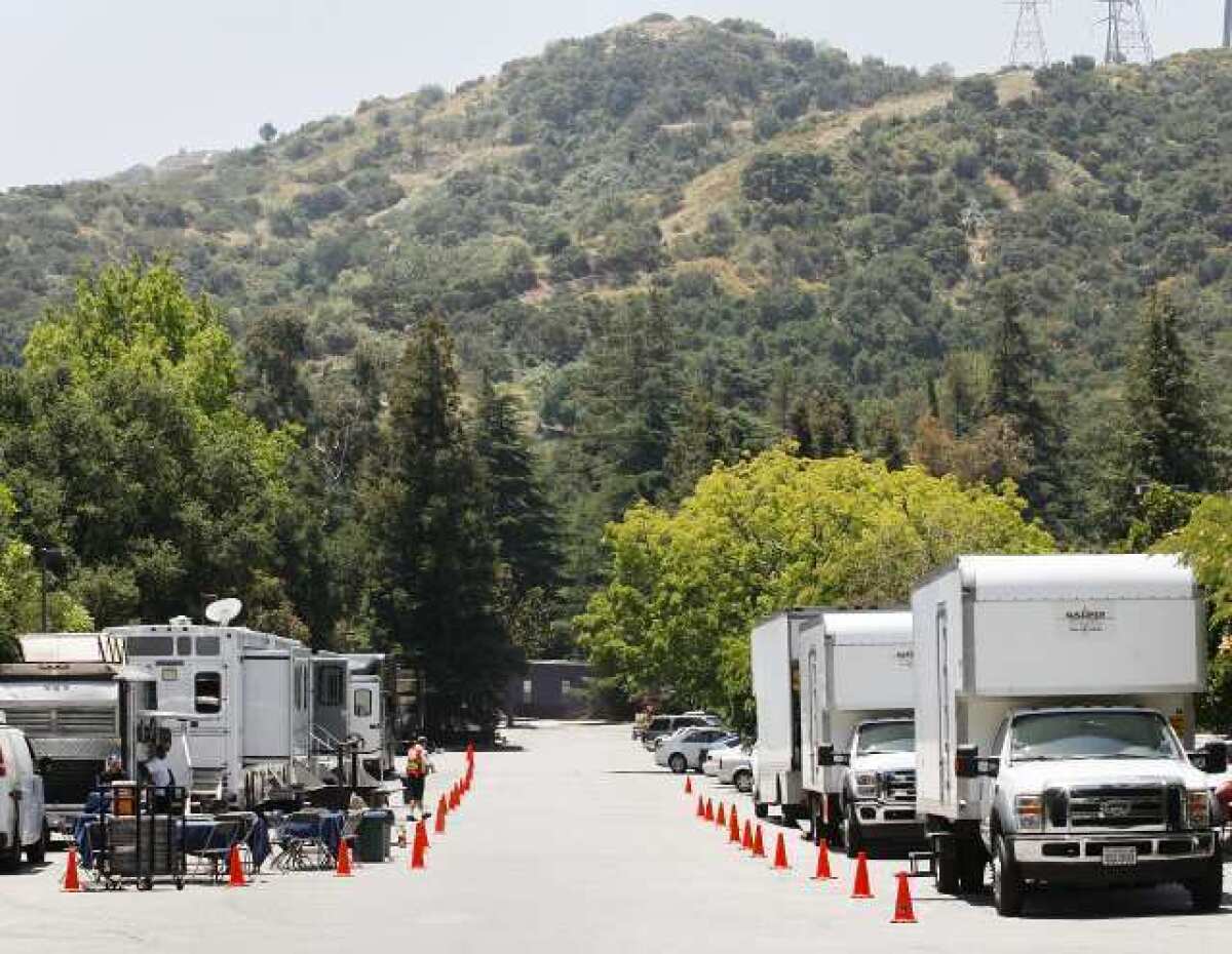 A caravan of production vehicles line up in the parking lot at Descanso Gardens in La Canada Flintridge for the filming of a McDonald's commercial.