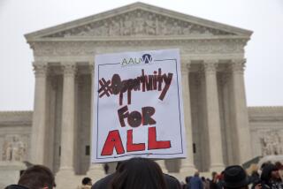 Pamela Yuen, with the American Association of University Women, holds a sign in favor of affirmative action outside of the Supreme Court in Washington, Wednesday, Dec. 9, 2015, as the court hears oral arguments in the Fisher v. University of Texas at Austin affirmative action case. (AP Photo/Jacquelyn Martin)