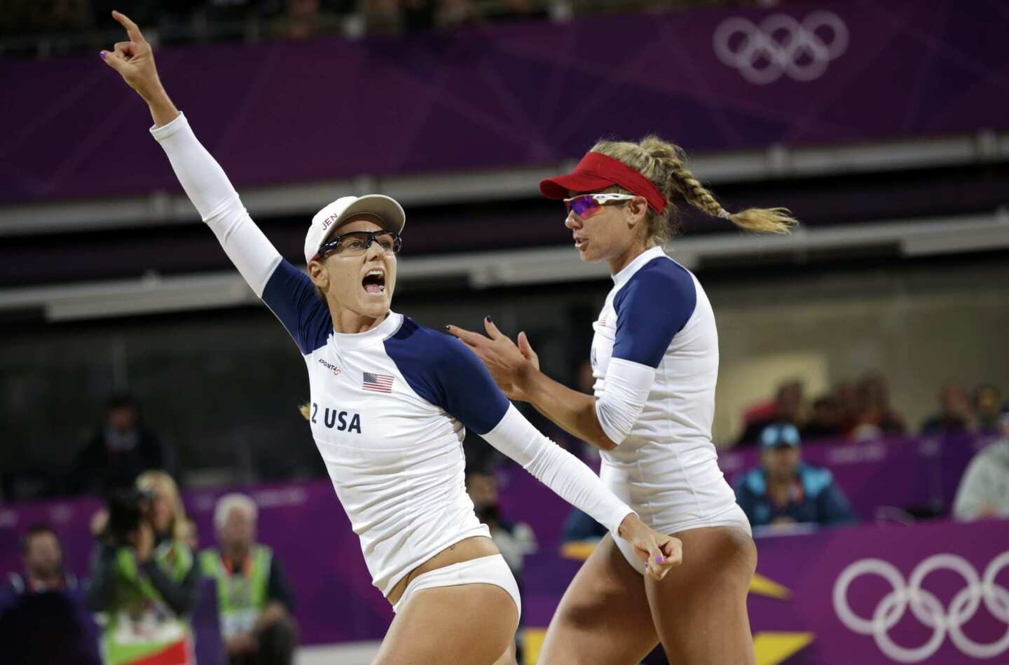 Jennifer Kessy, left, and April Ross of the U.S. cheer during their quarterfinal match against the Czech Republic. Both beach volleyball stars played for USC, though in different years.