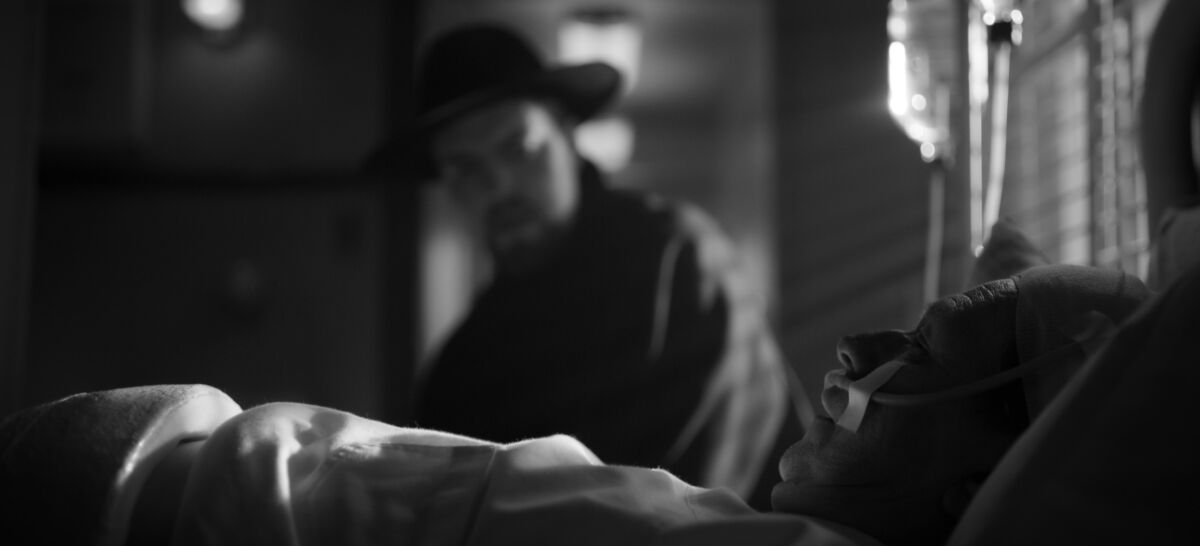 Orson Welles (Tom Burke) visits a hospitalized Herman J. Mankiewicz (Gary Oldman) in the movie "Mank."