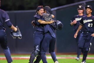 Catcher Nate Blum embraces relief pitcher Jake Chung after Harvard-Westlake 4-2 semifinal win over Orange Lutheran.