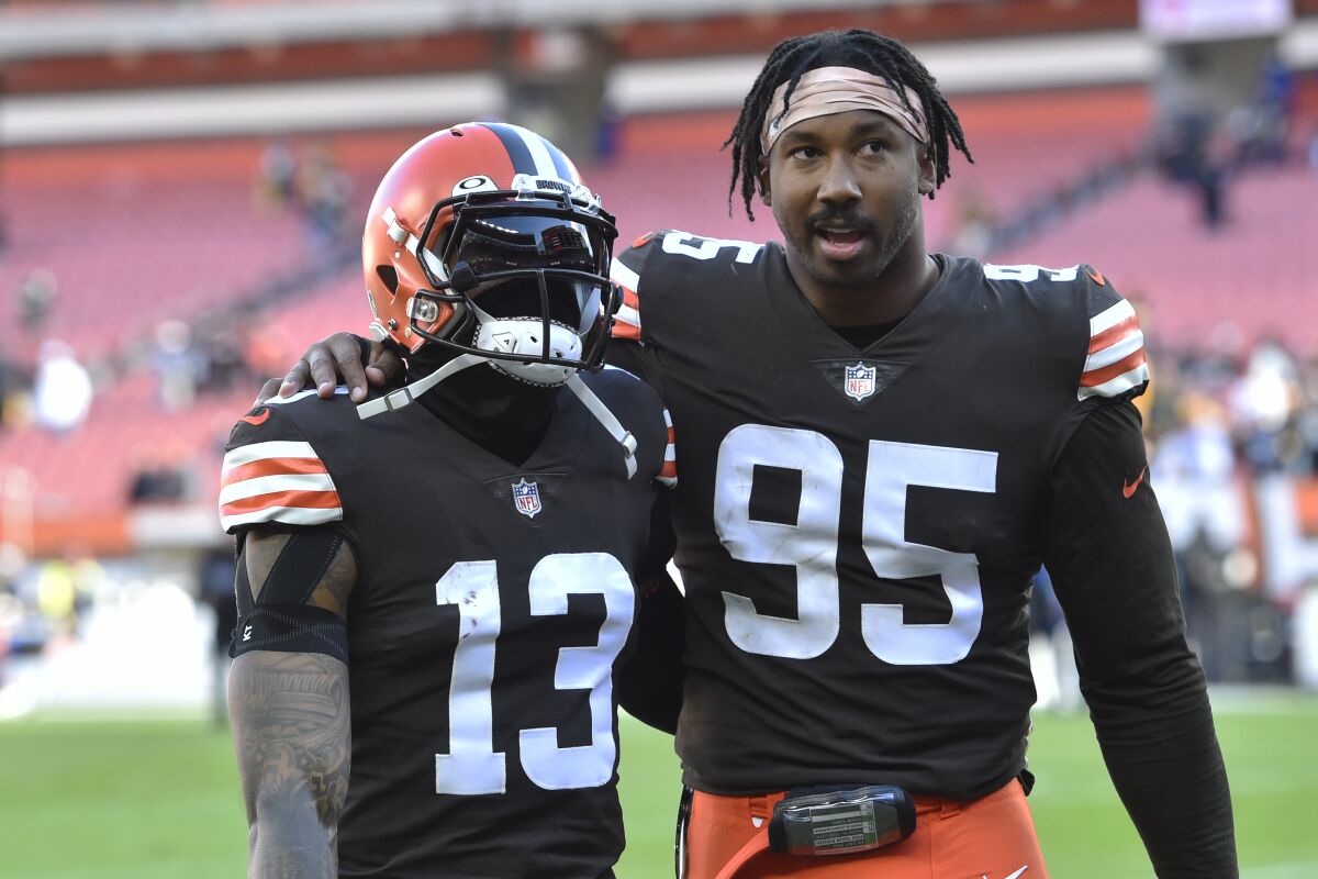 Cleveland Browns defensive end Myles Garrett (95) and wide receiver Odell Beckham Jr. (13) walk off the field after the Steelers defeated the Cleveland Browns 15-10 in an NFL football game, Sunday, Oct. 31, 2021, in Cleveland. (AP Photo/David Richard)