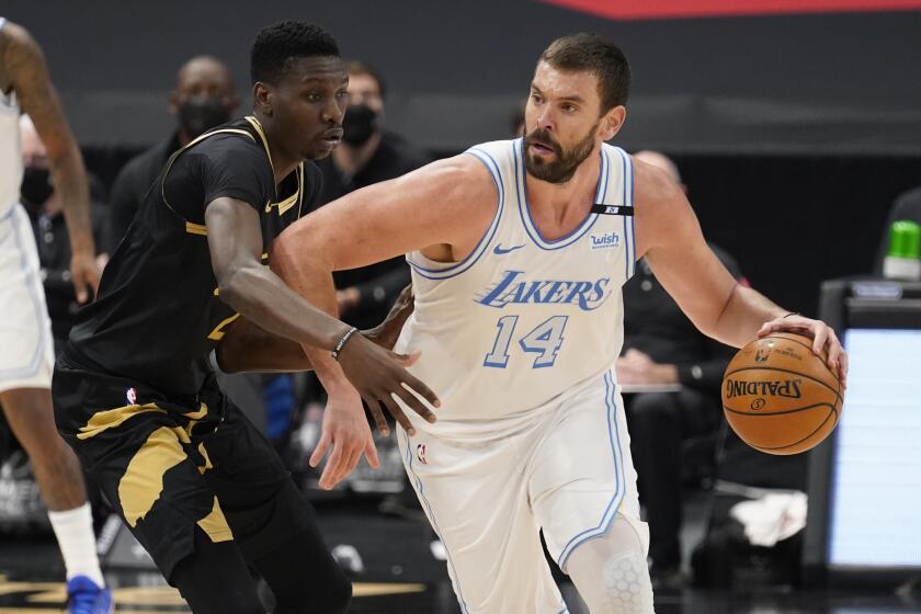 Los Angeles Lakers center Marc Gasol (14) drives at Toronto Raptors forward Chris Boucher (25) during the second half of an NBA basketball game Tuesday, April 6, 2021, in Tampa, Fla. (AP Photo/Chris O'Meara)
