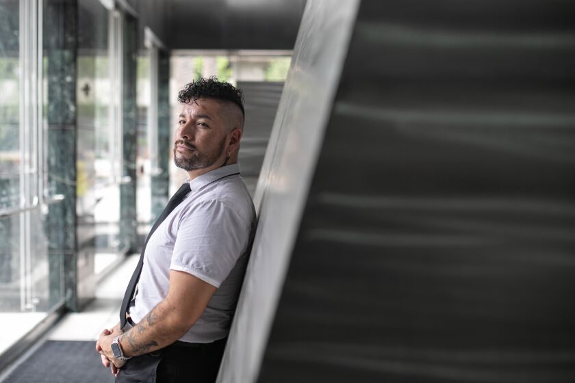 LOS ANGELES, CA - SEPTEMBER 10: Alessandro Negrete poses for a portrait in the lobby of the consulting firm where he works in downtown on Saturday, Sept. 10, 2022 in Los Angeles, CA. (Jason Armond / Los Angeles Times)
