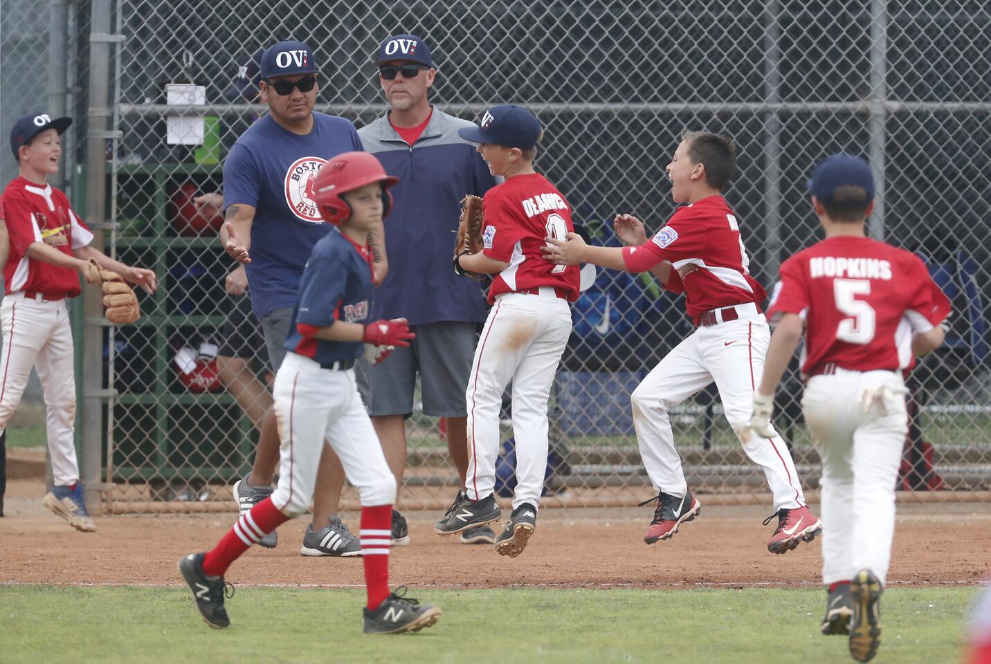 Ocean View Little League Cardinals celebrate beating the Ocean View Red Sox 1-0 in the District 62 Tournament of Champions Minor A Division championship game on Saturday at Ocean View Little League.
