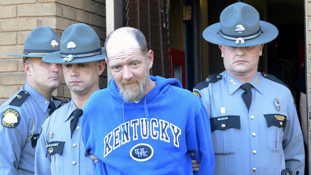 Kentucky state police escort Timothy Madden from State Police Post 3 in Bowling Green, Ky.
