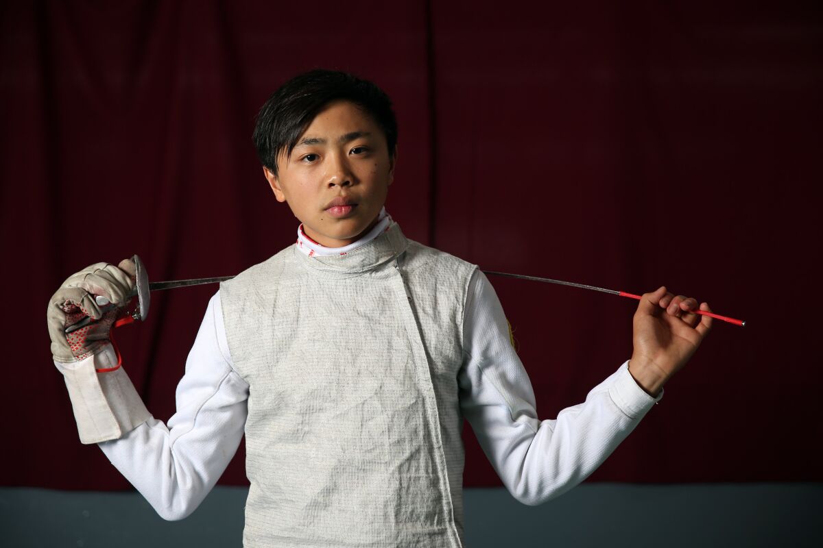 Bryce Louie poses for a portrait at the Los Angeles International Fencing Center.