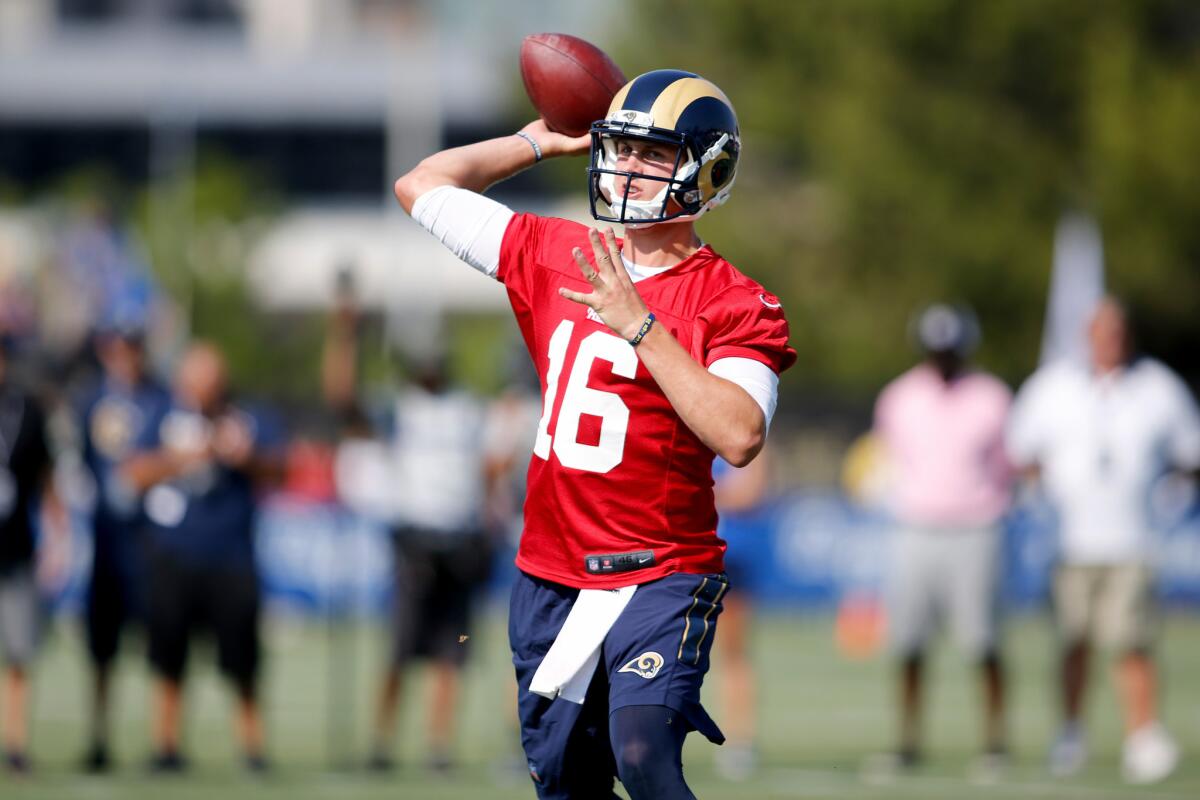 Rams rookie quarterback Jared Goff (16) runs through a drill during the first day of training camp on July 30.