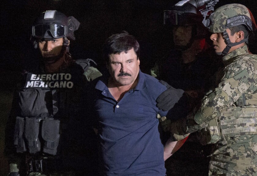 Mexican drug lord Joaquin "El Chapo" Guzman is escorted by army soldiers to a waiting helicopter in Mexico City on Jan. 8, 2016, after he was recaptured.