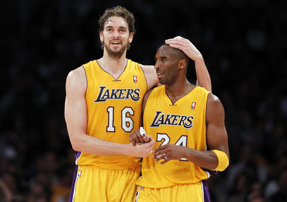 Lakers' Pau Gasol embraces teammate Kobe Bryant during a 2010 game. 