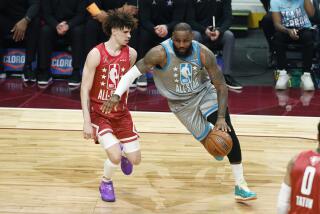 Los Angeles Lakers' LeBron James drives against Charlotte Hornets' LaMelo Ball during the first half of the NBA All-Star basketball game, Sunday, Feb. 20, 2022, in Cleveland. (AP Photo/Ron Schwane)