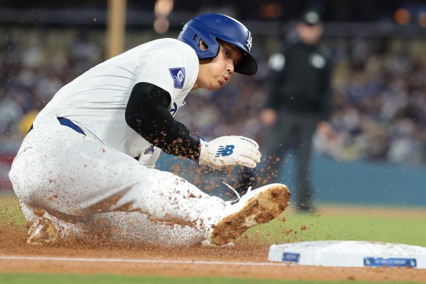 LOS ANGELES, CALIFORNIA May 21, 2024-Dodgers Shohei Ohtani steals third base and would eventually score on an error by the Diamondbacks in the fourth inning at Dodgers Stadium Tuesday. (Wally Skalij/Los Angeles Times)
