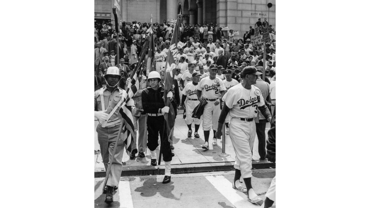 April 18, 1958: Members of the Dodgers leave reception at City Hall to play their first game at the Los Angeles Memorial Coliseum.