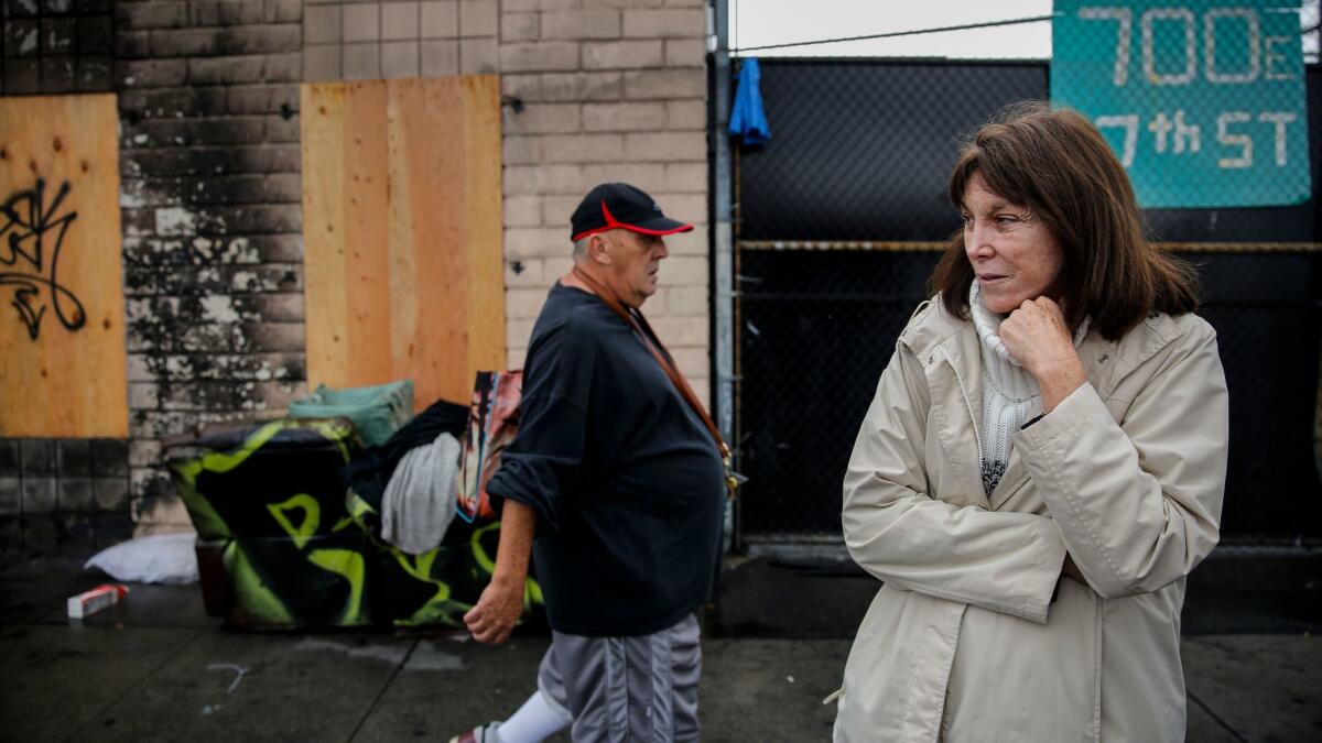 Lisa Rich stands outside her fire-damaged property on East 7th Street. A December blaze engulfed a tent on skid row and spread to her warehouse.