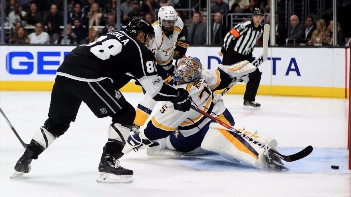 Kings winger Jarome Iginla slips the puck past Predators goaltender Pekka Rinne during the second period of a game on March 9 at Staples Center.