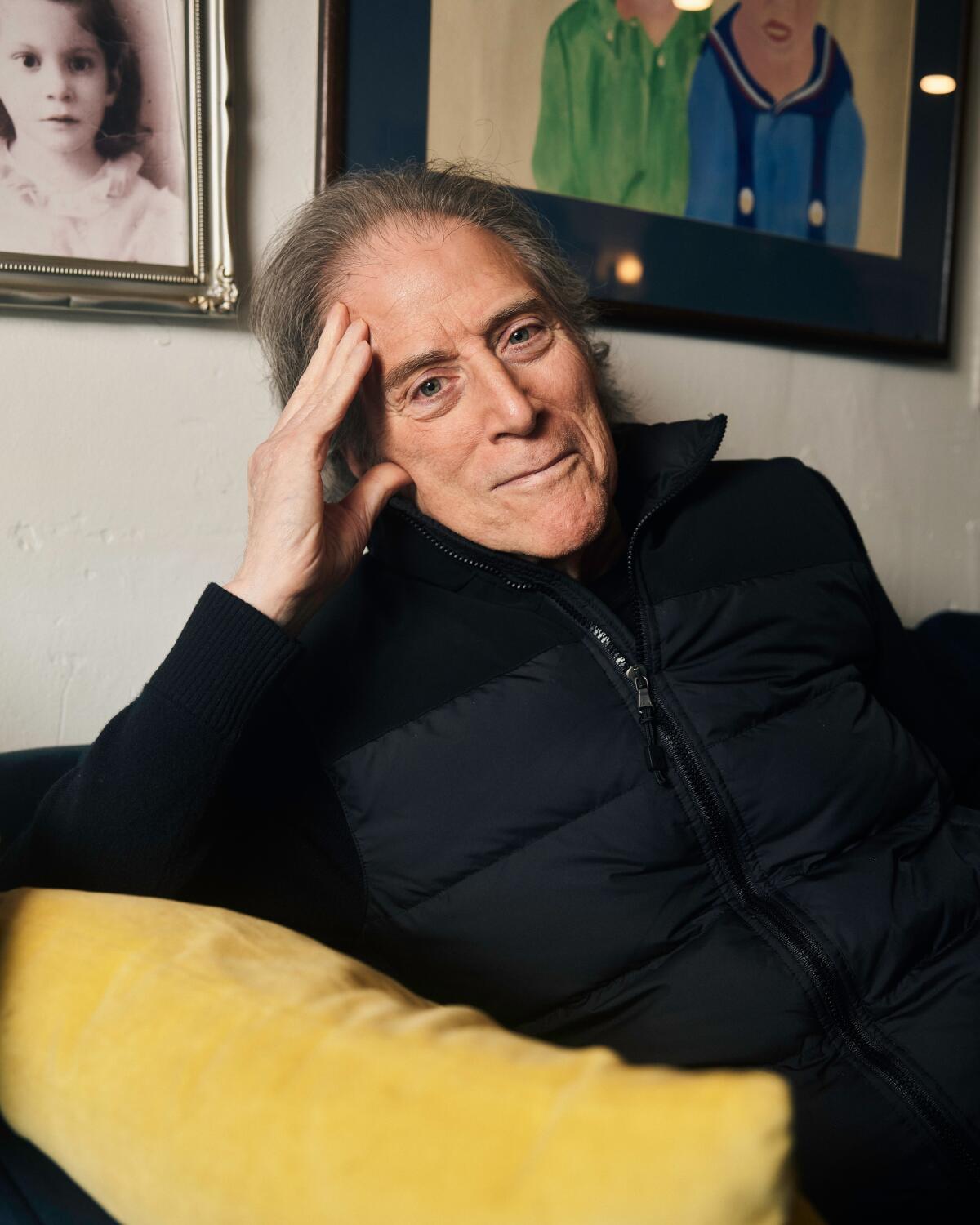 Richard Lewis sits in a yellow chair with his head resting on his hand