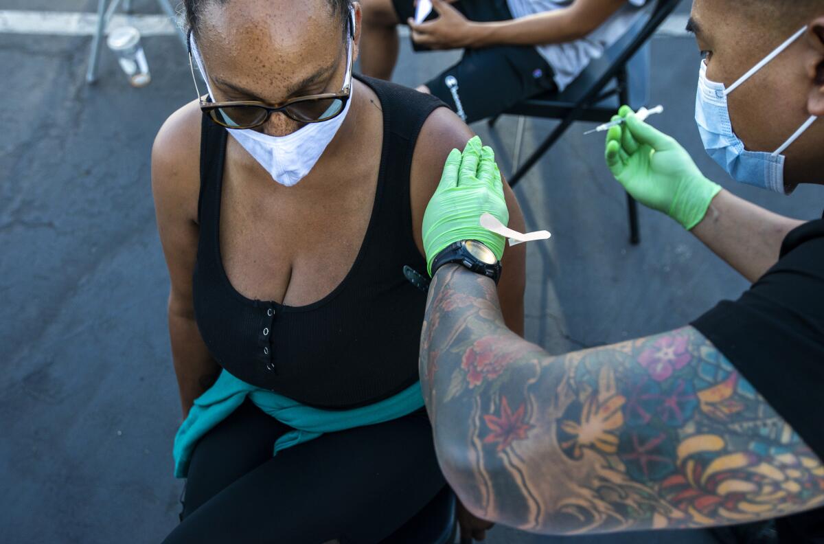 A woman gets a COVID-19 vaccine.