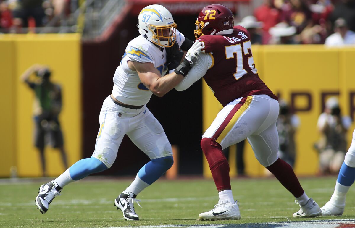 Chargers defensive end Joey Bosa (97) tries to fight off a block in game against Washington.
