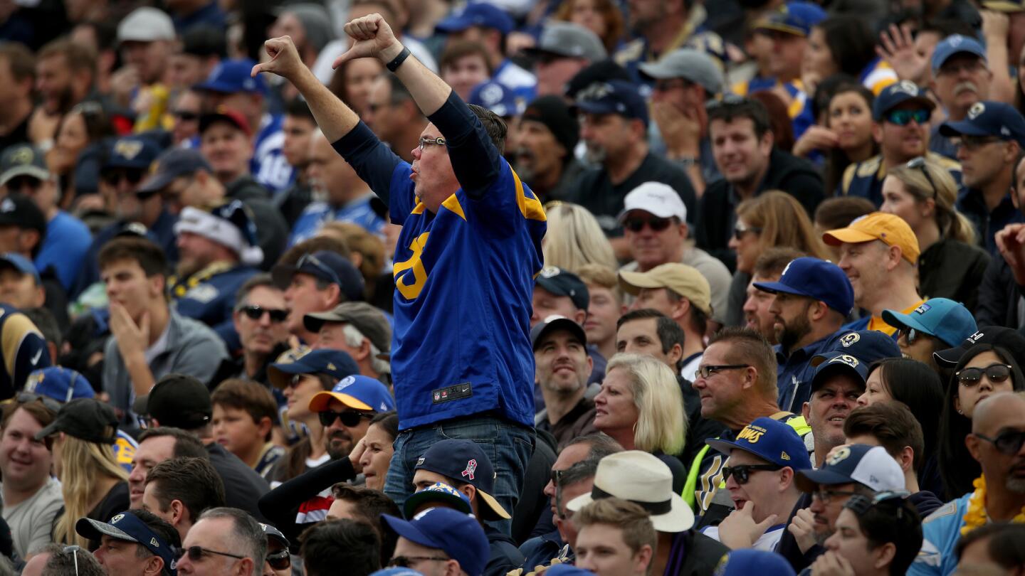 A Rams fan joins a chorus of "boos" as they express their disappointment in the team during the first half of a 42-14 loss to Atlanta.