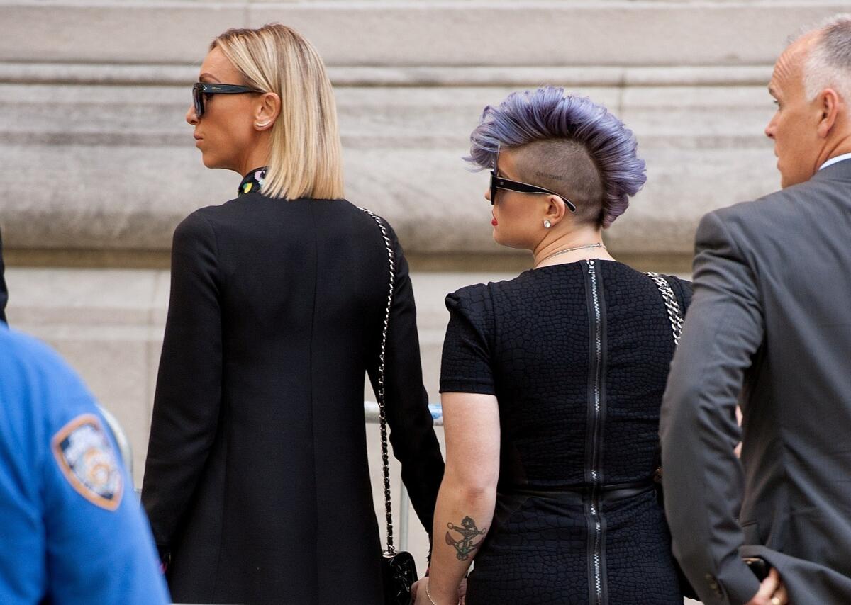Joan Rivers' "Fashion Police" co-hosts Giuliana Rancic, left, and Kelly Osbourne arrive at her funeral at Temple Emanu-El in New York.