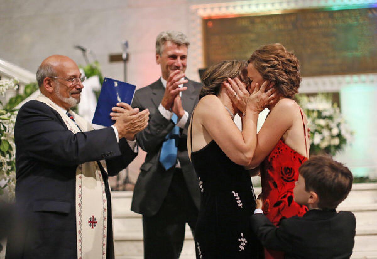 Margaret Miles and Cathy ten Broeke kiss after they were wed early Thursday on the steps of the rotunda at Minneapolis City Hall by the Rev. James Gertmenian, far left, and Mayor R. T. Rybak.