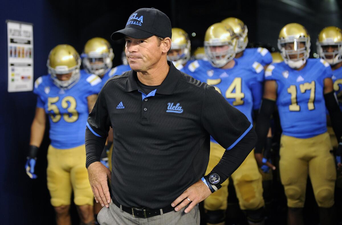 UCLA Coach Jim Mora prepares to lead his team on to the field before a game against Texas on Sept. 13.