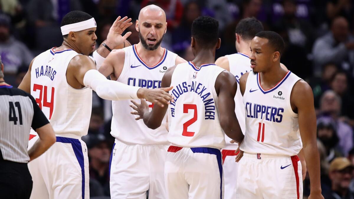 Clippers' Marcin Gortat is congratulated by teammates after he was fouled during their game against the Sacramento Kings.