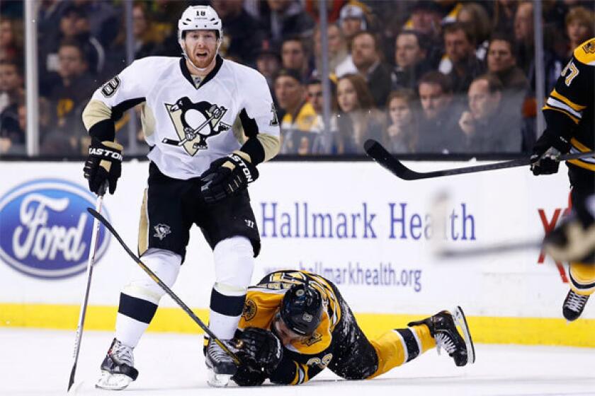 Boston's Brad Marchand is kneed in the head by Pittsburgh's James Neal on Saturday at TD Garden in Boston.