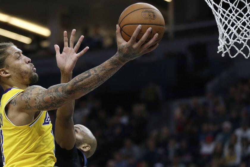 Los Angeles Lakers' Michael Beasley, left, shoots over the defense of Minnesota Timberwolves' Taj Gibson in the second half of an NBA basketball game Sunday, Jan. 6, 2019, in Minneapolis. (AP Photo/Stacy Bengs)