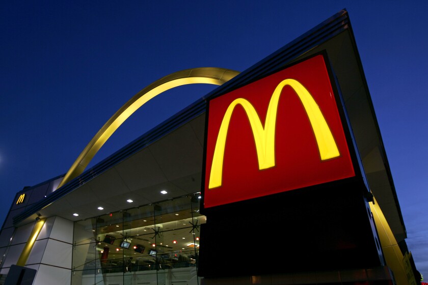 FILE - In this April 20, 2006 file photo, a McDonald's restaurant logo and golden arch is lit in Chicago'. McDonald’s investors will consider a proposal for a civil rights audit of the company after the federal government denied McDonald’s request to remove the proposal from the agenda at its annual meeting. (AP Photo/Jeff Roberson, File)