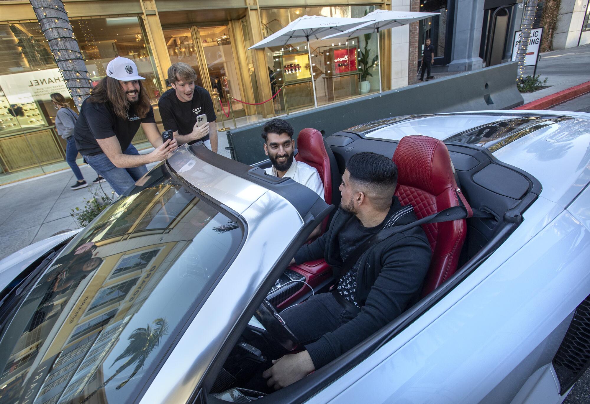 A car stopped at a red light on Rodeo Drive in Beverly Hills