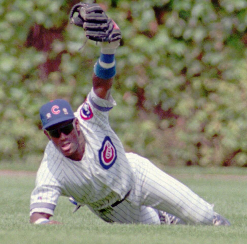 Sammy Sosa makes a diving grab of the Expos' Larry Walker's line drive to center field at Wrigley Field on Aug. 17, 1993.