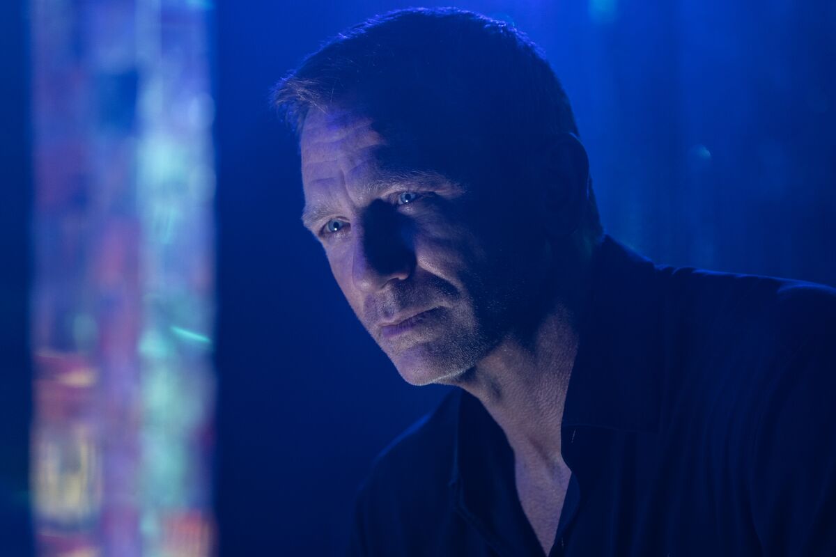 Daniel Craig in a dark shirt in a scene from "No Time to Die" 
