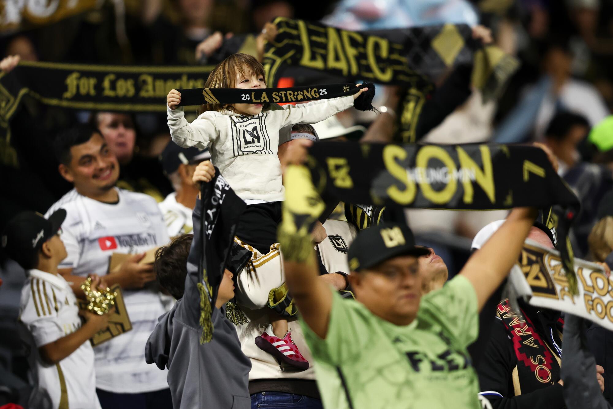 Los Angeles FC fans hold scarves before an MLS soccer matchv